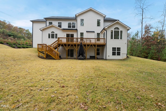 rear view of property with a yard and a wooden deck