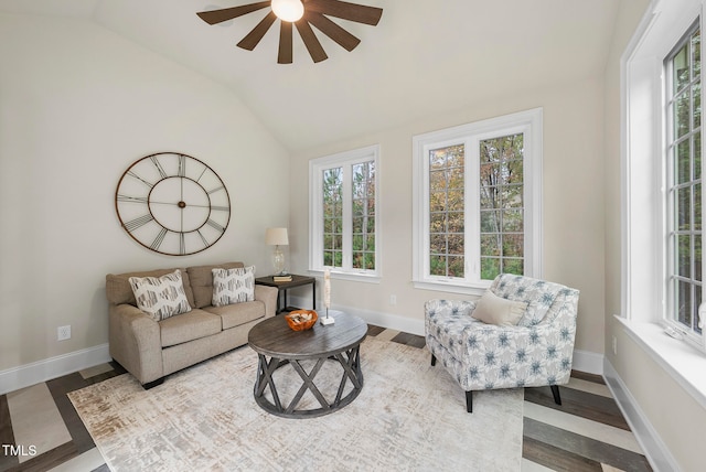 living room with wood-type flooring, vaulted ceiling, and ceiling fan