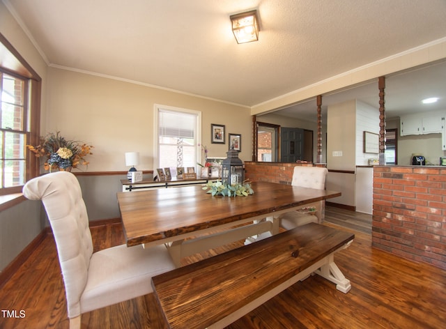 dining room with a textured ceiling, dark hardwood / wood-style flooring, and ornamental molding