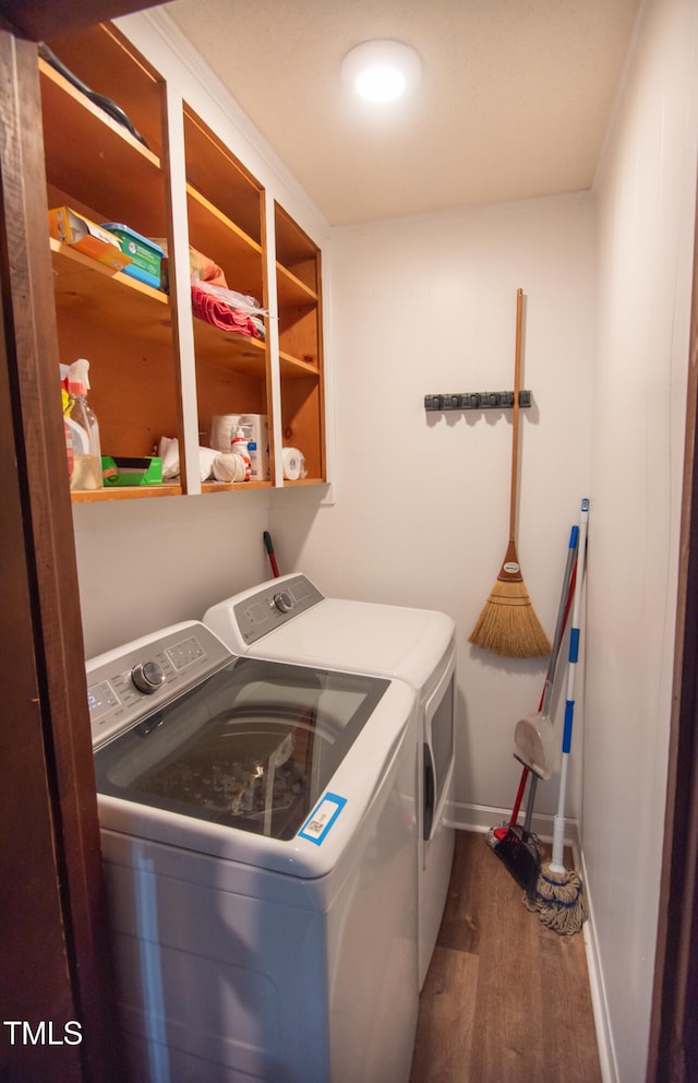 washroom with hardwood / wood-style floors and separate washer and dryer