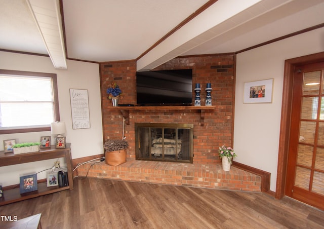 living room featuring a fireplace, hardwood / wood-style floors, and ornamental molding