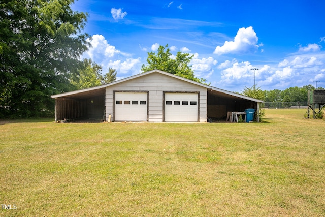 garage with a yard and a carport