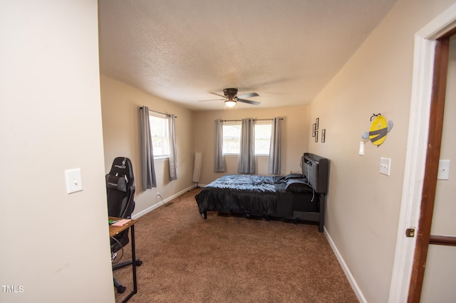 bedroom with a textured ceiling, carpet floors, and ceiling fan