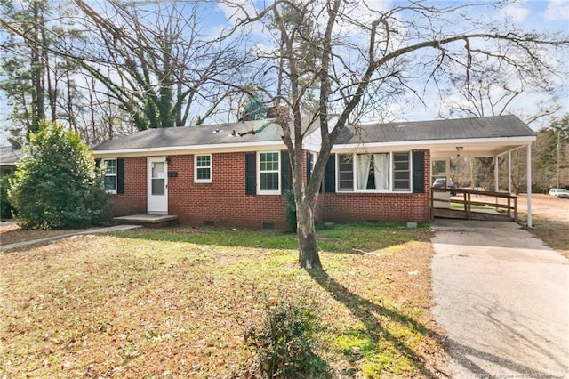 ranch-style house with a carport and a front lawn