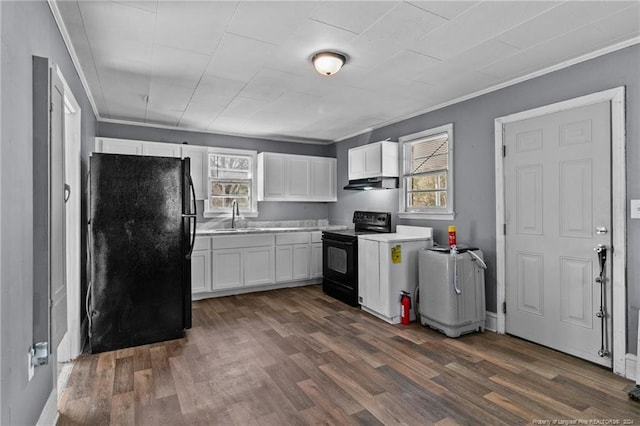 kitchen with black appliances, ornamental molding, dark hardwood / wood-style floors, sink, and white cabinets