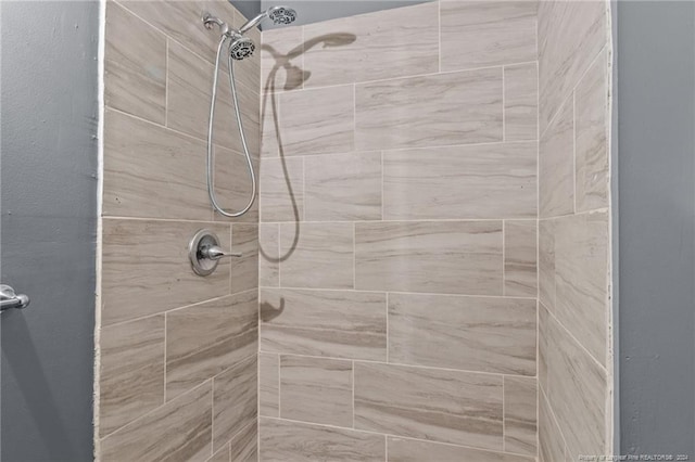 bathroom with a tile shower