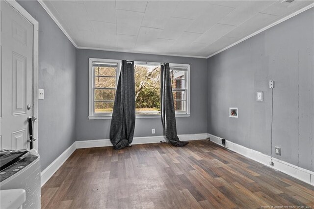 spare room featuring dark wood-type flooring and crown molding