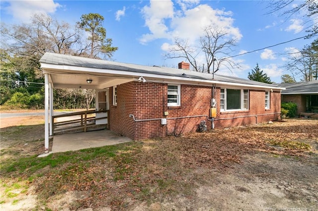 rear view of house featuring a carport