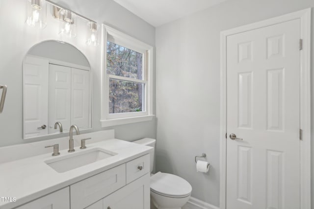 bathroom featuring vanity and toilet