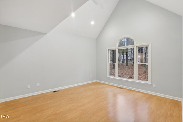 interior space with hardwood / wood-style flooring and high vaulted ceiling