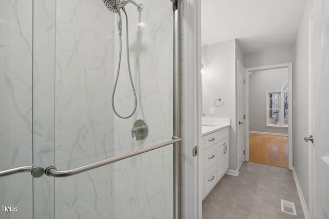 bathroom with hardwood / wood-style floors, vanity, and an enclosed shower