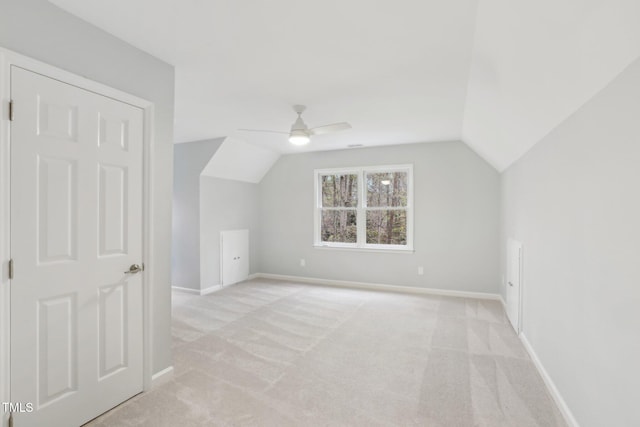 additional living space featuring light carpet, ceiling fan, and lofted ceiling