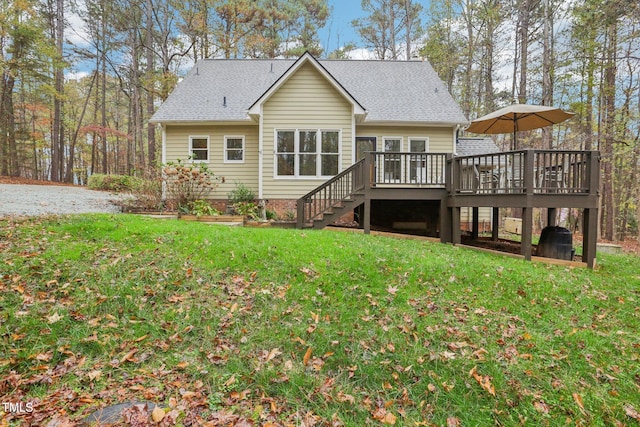 back of house with a wooden deck and a yard