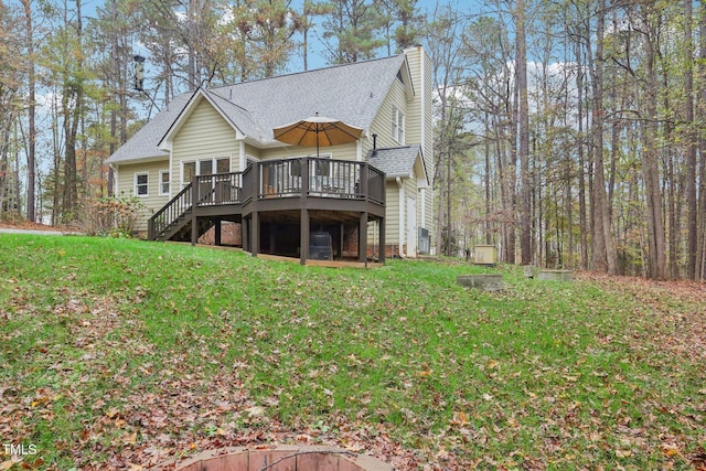 back of property with a lawn and a wooden deck