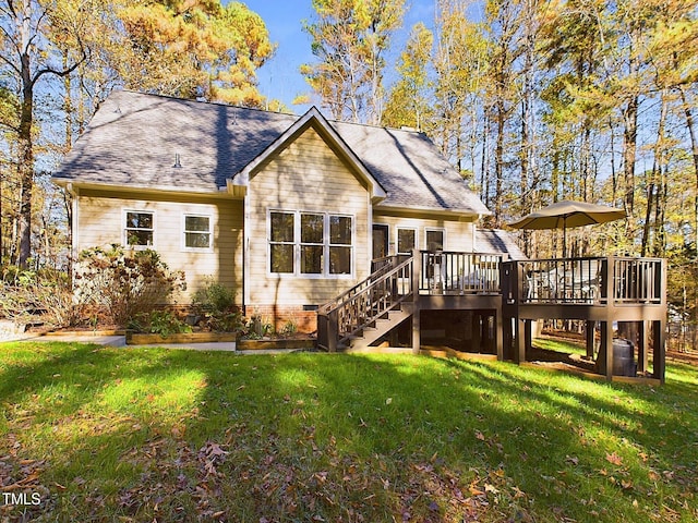 rear view of house with a yard and a deck