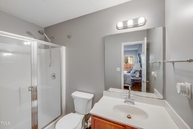 bathroom with a textured ceiling, vanity, toilet, and walk in shower