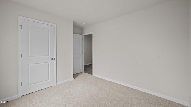 unfurnished bedroom featuring light colored carpet