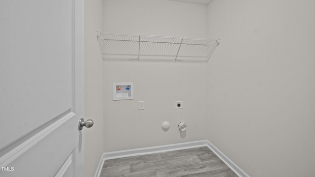 laundry room with hardwood / wood-style flooring, hookup for a washing machine, hookup for a gas dryer, and hookup for an electric dryer