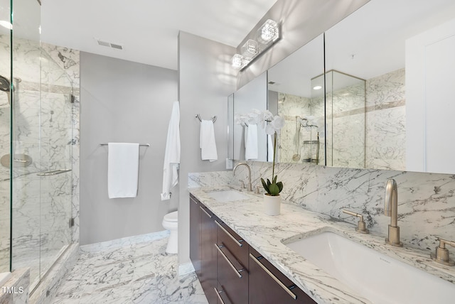 bathroom featuring vanity, toilet, and walk in shower