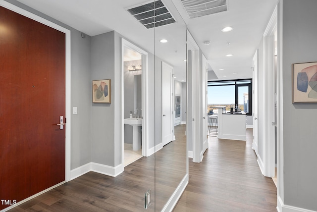 corridor with hardwood / wood-style flooring