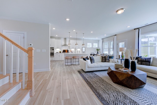 living room with light hardwood / wood-style floors and sink