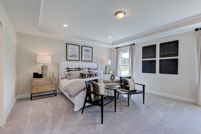 bedroom featuring a tray ceiling, light colored carpet, and ornamental molding