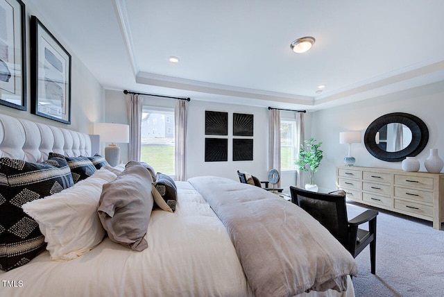 carpeted bedroom with a raised ceiling, multiple windows, and crown molding