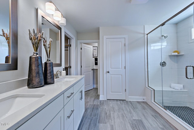 bathroom with vanity, wood-type flooring, and a shower with door