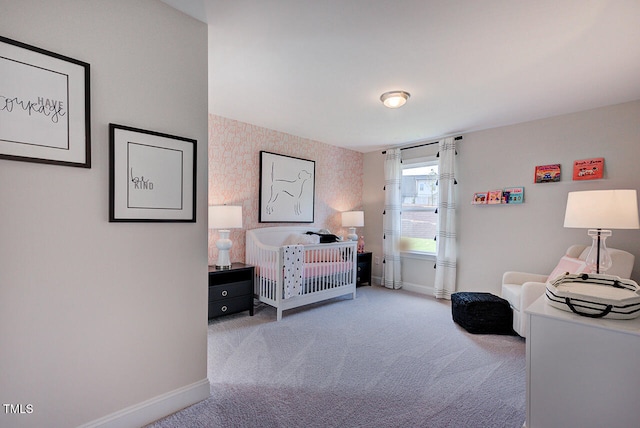 carpeted bedroom with a crib