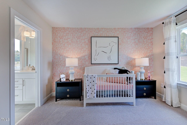 904 Delano Dr, Knightdale, NC 27545 - carpeted bedroom featuring wallpapered walls, baseboards, a sink, and connected bathroom