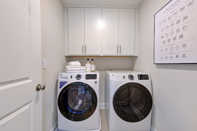 clothes washing area with cabinets and separate washer and dryer