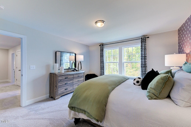 bedroom featuring light carpet