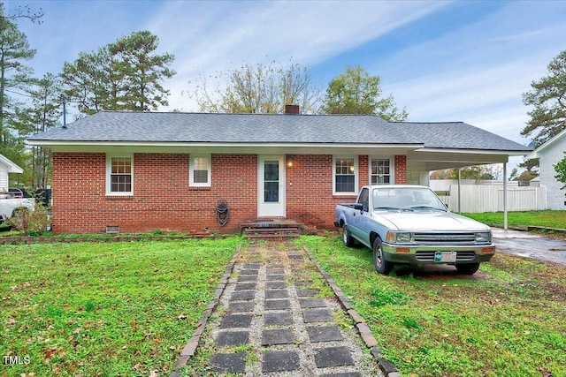 ranch-style home featuring a carport and a front lawn