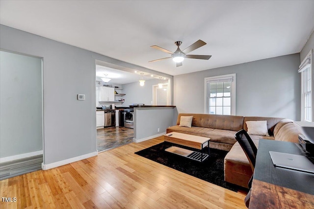 living room with hardwood / wood-style flooring and ceiling fan