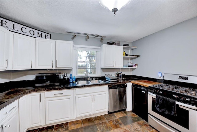 kitchen with white cabinets, stainless steel dishwasher, a textured ceiling, sink, and white range with gas stovetop