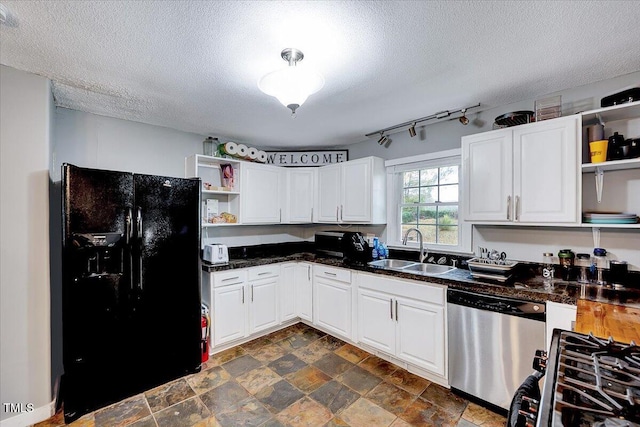 kitchen with a textured ceiling, stainless steel appliances, white cabinetry, and sink