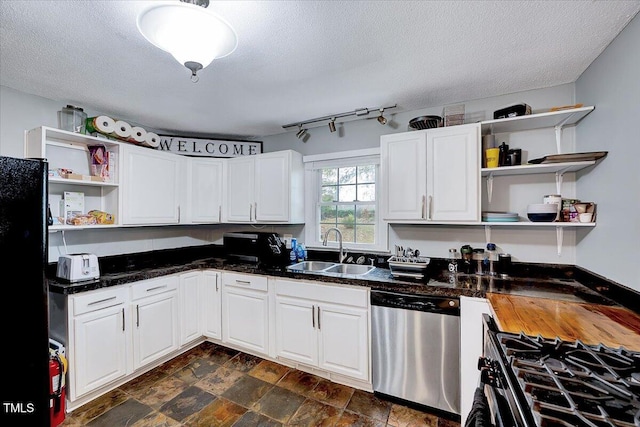 kitchen featuring white cabinets, appliances with stainless steel finishes, a textured ceiling, and sink