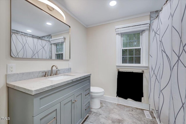 bathroom with vanity, ornamental molding, and toilet