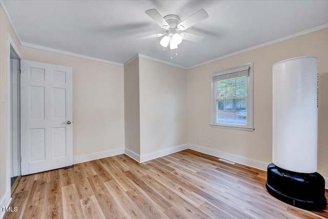 empty room with ceiling fan, light hardwood / wood-style flooring, and ornamental molding