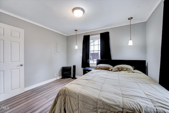 bedroom with hardwood / wood-style flooring and ornamental molding