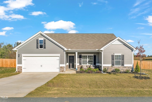 view of front facade featuring covered porch, a front yard, and a garage