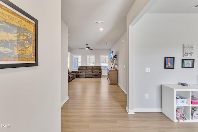 corridor with light hardwood / wood-style floors