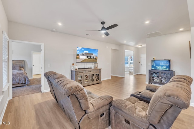 living room featuring ceiling fan and light hardwood / wood-style floors