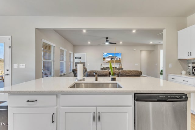 kitchen with plenty of natural light, white cabinets, stainless steel dishwasher, and sink