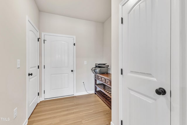 hallway with light hardwood / wood-style flooring