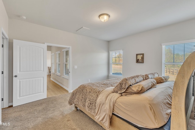 bedroom featuring light hardwood / wood-style floors and multiple windows