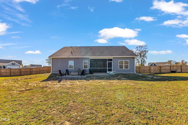 back of property featuring a yard, a sunroom, and a patio area