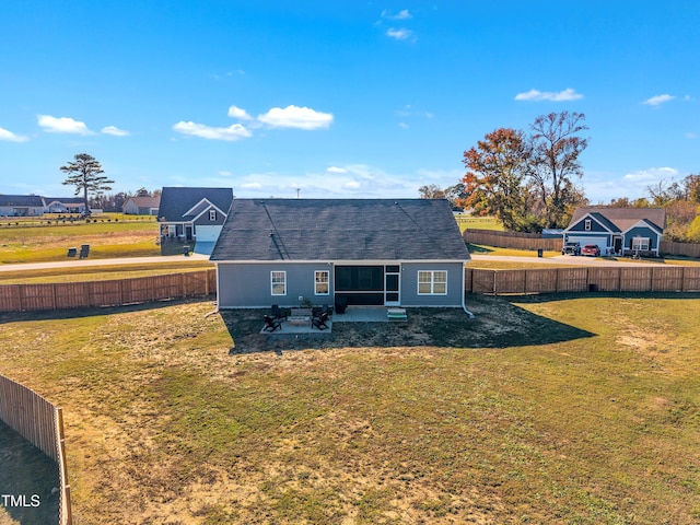 back of house with a patio area and a yard