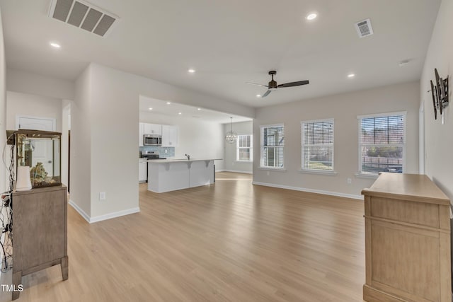 living area featuring recessed lighting, visible vents, and light wood-style flooring