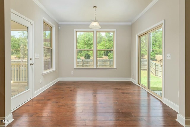 unfurnished dining area featuring a healthy amount of sunlight, dark hardwood / wood-style floors, and crown molding